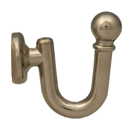 Wall mounted curtain tie back hook. Designed as metal ball end at top of a U-shaped metal hook