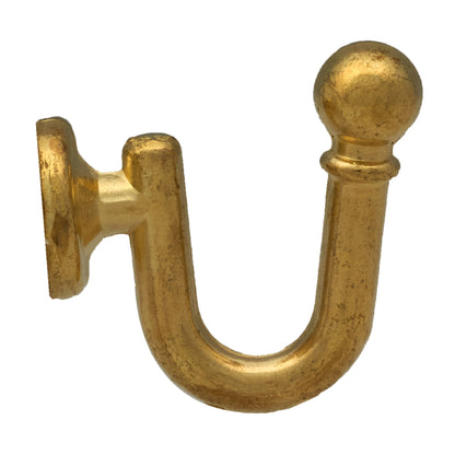 Wall mounted curtain tie back hook. Designed as metal ball end at top of a U-shaped metal hook